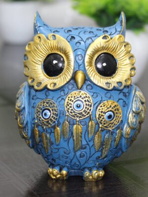 Handcrafted blue and gold resin owl statue featuring evil eye and dreamcatcher designs, ideal for positive Vastu home decor.