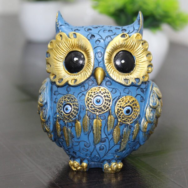 Handcrafted blue and gold resin owl statue featuring evil eye and dreamcatcher designs, ideal for positive Vastu home decor.