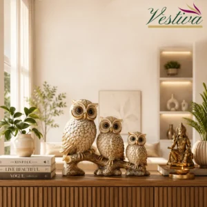 Elegant owl family showpiece for home decor placed on a wooden console table in a modern living room with Vastu-inspired placement ideas by Vestiva.