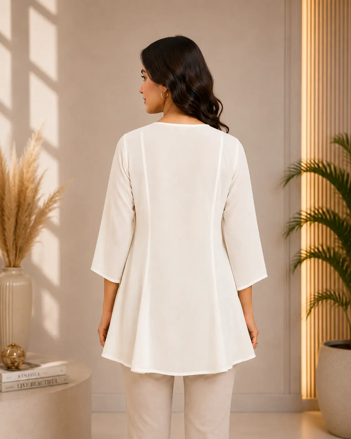 side angle view of women off white georgette tunic top showing breathable fluid drape and 3 4 sleeves