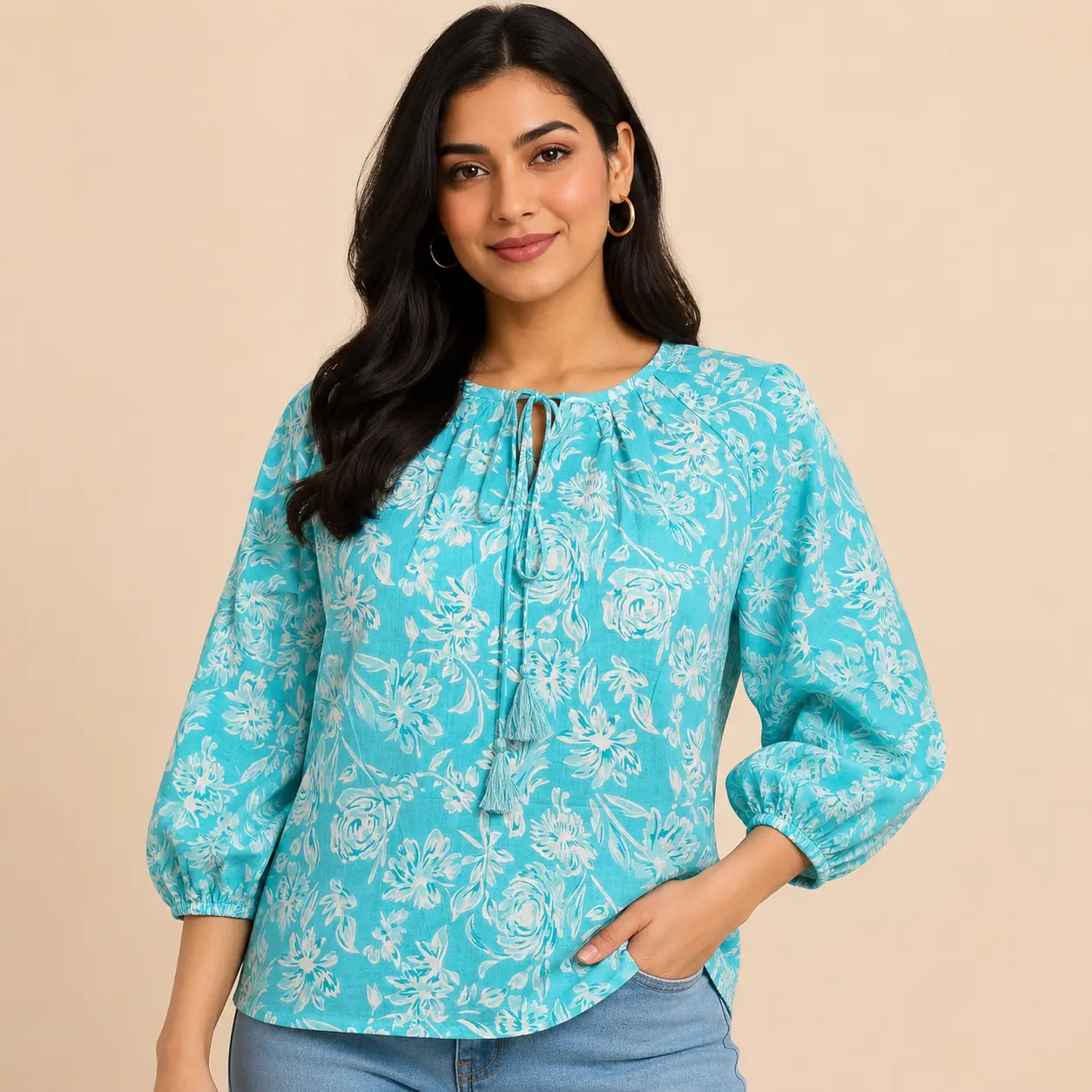 Front view of women sky blue floral printed cotton top with tie neck tassel detail