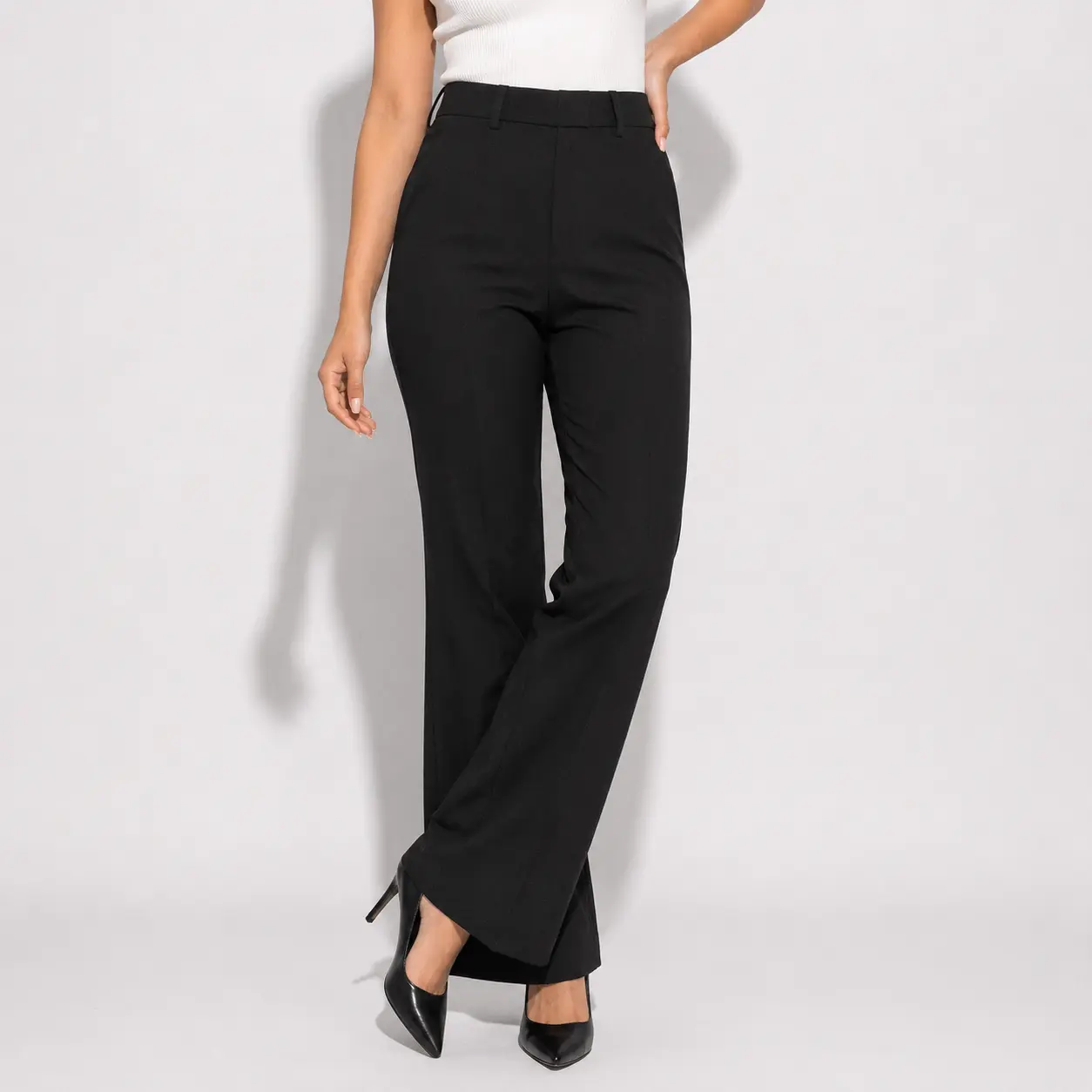 Front view of model wearing lavender high waist straight flared trousers with white top