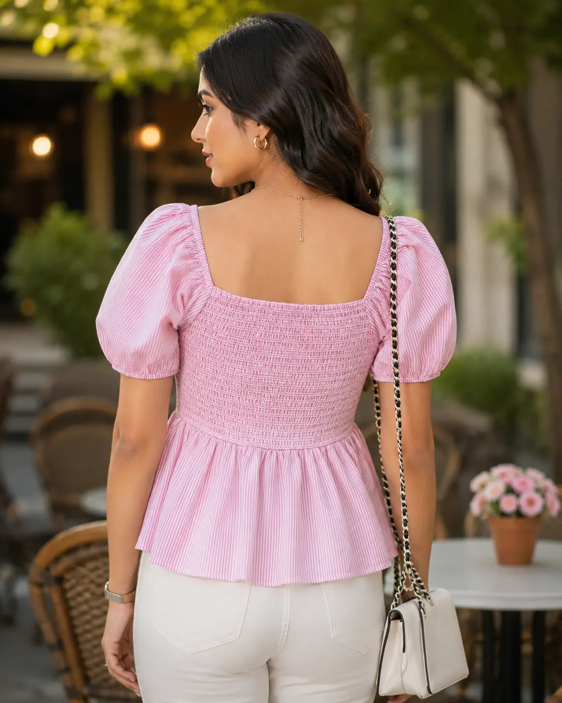 Women's pink and white striped peplum top back view showcasing the striped pattern, fitted smocked back bodice, short puff sleeves and flared peplum hem, stylish casual women's clothing by Voniva Fashion