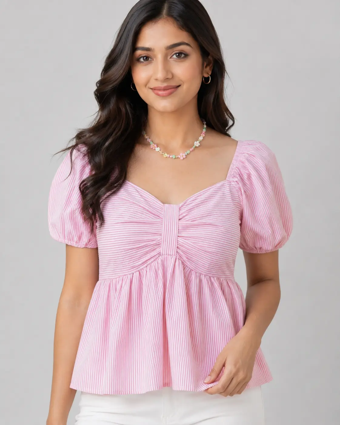 Close-up view of women's pink and white striped peplum top highlighting the sweetheart neckline, short puff sleeve details, striped fabric pattern and fitted smocked bodice, stylish women's fashion top by Voniva Fashion